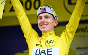 Slovenian Tadej Pogacar of UAE Team Emirates celebrates on the podium after winning stage 19 of the 2024 Tour de France cycling race, from Embrun to Isola 2000 (144,6 km), in France, on Friday 19 July 2024. The 111th edition of the Tour de France starts on Saturday 29 June and will finish in Nice, France on 21 July. BELGA PHOTO TOM GOYVAERTS (Photo by Tom Goyvaerts / BELGA MAG / Belga via AFP)