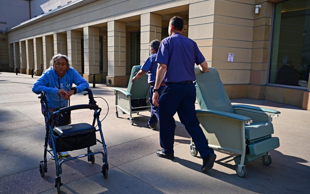 People arrive at an evacuation center in the Pasadena Convention Center in Pasadena, California, as they flee wildfires in the Los Angeles area on January 10, 2025. Massive wildfires that engulfed whole neighborhoods and displaced thousands in Los Angeles have killed at least 10 people, authorities said, as California's National Guard soldiers readied to hit the streets to help quell disorder.
News of the growing toll, announced late Thursday January 9 by the Los Angeles County Medical Examiner, came as swaths of the United States' second-largest city lay in ruins. (Photo by Agustin PAULLIER / AFP)