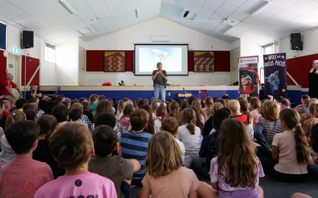 Author Avril McDonald reading the Wolf and the Hocus Pocus at a Wellington primary school that will receive a new book.