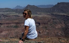 New Zealander Flick Taylor sitting on the edge of the Tekeze Gorge in Ethiopia on a helicopter recce safari in October 2019.