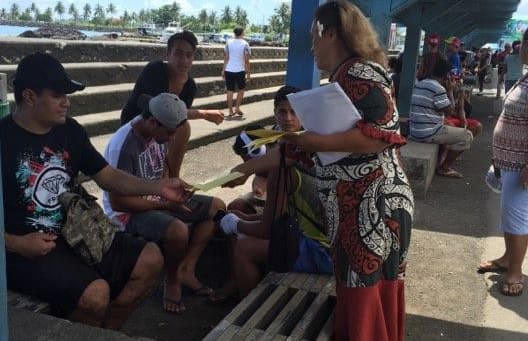 Samoa Solidarity International Group Ruta Lealaitafea Westin handing out pamphlets about the march to people at the Makeki in Apia.