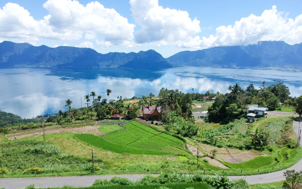 An aerial view is showing Lake Maninjau in Agam Regency, West Sumatra, Indonesia, on July 11, 2024. The Maninjau caldera is being formed by a volcanic eruption estimated to have occurred around 52,000 years ago. (Photo by Adriana Adie/NurPhoto) (Photo by Adriana Adie / NurPhoto / NurPhoto via AFP)