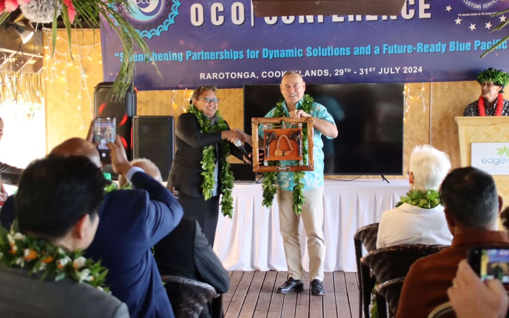 Prime Minister Mark Brown receives a gift from Oceania Customs Organisation head of secretariat Nancy T Oraka at The Edgewater Resort and Spa conference room on Monday. OCO/24072914