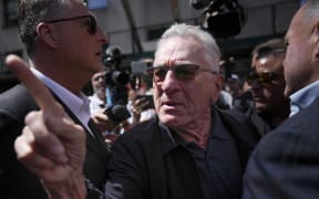 Robert De Niro, center, argues with a former President Donald Trump supporter after speaking to reporters in support of President Joe Biden across the street from Trump's criminal trial in New York, Tuesday, May 28, 2024. (AP Photo/Seth Wenig)