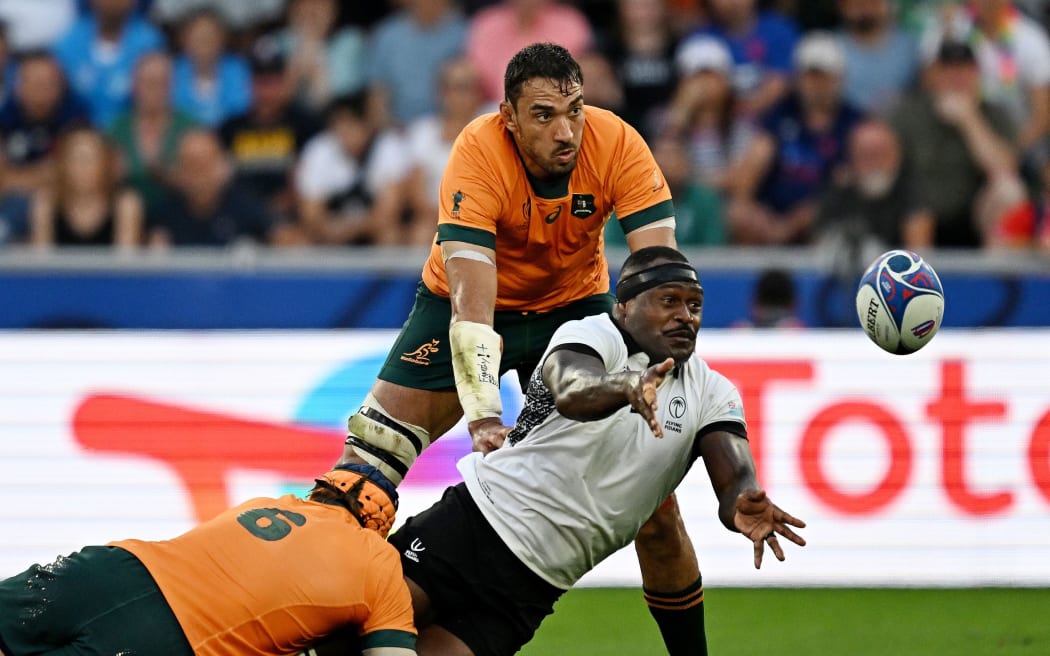 Levani Botia of Fiji passes the ball whilst under pressure from Tom Hooper and Richard Arnold of Australia during the Rugby World Cup France 2023 match between Australia and Fiji at Stade Geoffroy-Guichard on September 17, 2023 in Saint-Etienne, France. (Photo by Pauline Ballet - World Rugby/World Rugby via Getty Images)