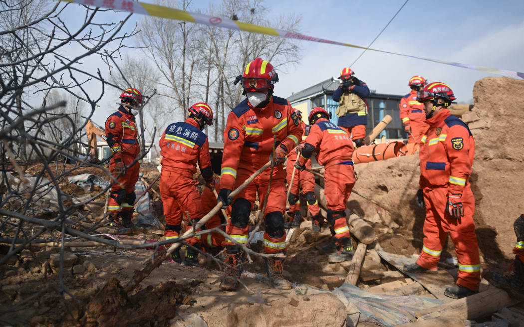 (231219) -- MINHE, Dec. 19, 2023 (Xinhua) -- Rescuers are in operation at Jintian Village of Minhe County in Haidong City, northwest China's Qinghai Province, Dec. 19, 2023. The 6.2-magnitude earthquake that jolted an ethnic county in northwest China's Gansu Province around midnight Monday has killed 14 people in the neighboring Qinghai Province, local authorities said on Tuesday.
   As of 4:50 p.m. Tuesday, 198 people in Qinghai have been injured as a result of the earthquake, according to the emergency management bureau of Haidong City in Qinghai. (Xinhua/Zhang Long) (Photo by Zhang Long / XINHUA / Xinhua via AFP)