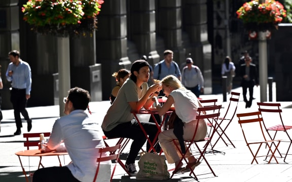 People spend their lunch hour in the central business district of Sydney on November 3, 2020. (Photo by Saeed KHAN / AFP)