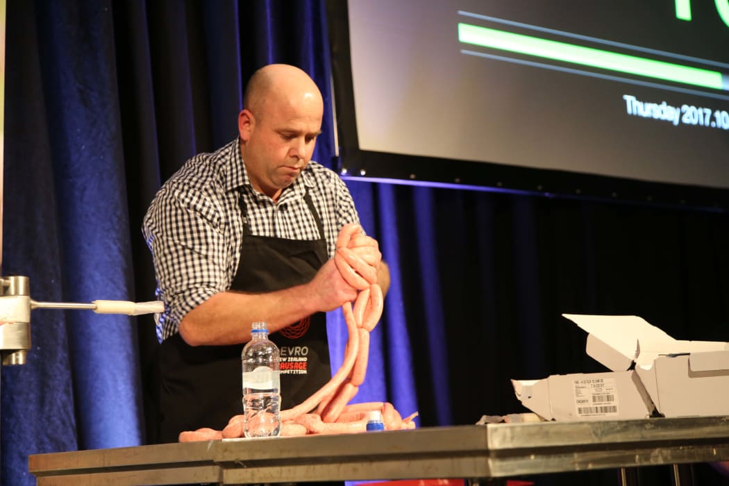 Corey Winder linking sausages