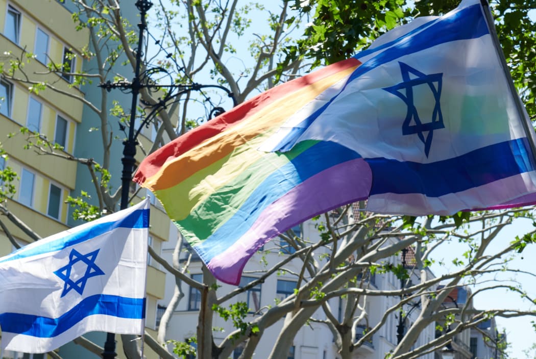 01 June 2019, Berlin: Israeli flags and the rainbow flag blow in the wind during a pro-Israel demonstration.