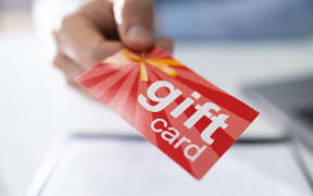 Close-up Of A Businessperson Hands Giving Gift Card