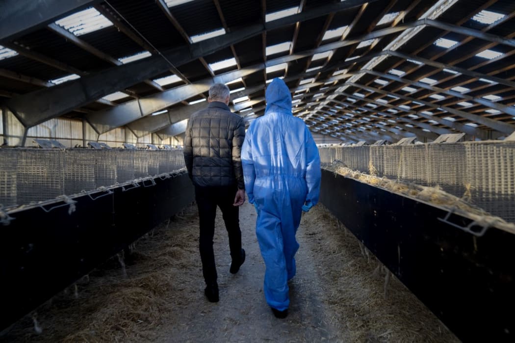Denmark's Prime Minister Mette Frederiksen (R) and mink breeder Peter Hindbo visit the closed and empty farm near Kolding, Denmark.