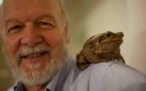 Professor Rick Shine with a cane toad on his shoulder