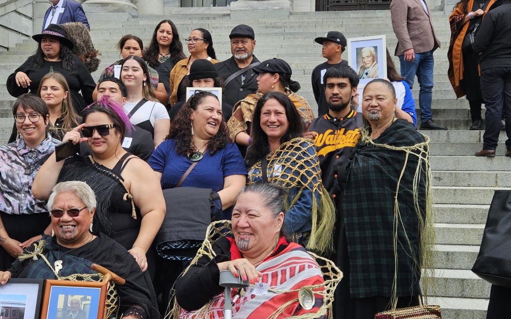 Members of Ngāti Pāoa outside Parliament after the iwi's Treaty Settlement passed its third reading. Many are carrying photographs of relatives who have passed away over the long years of negotiation between the iwi and the Crown.
