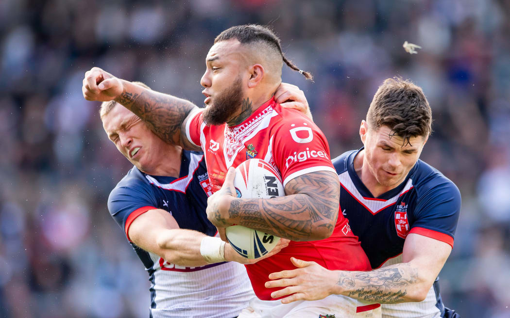 Tonga's Addin Fonua-Blake is tackled by England's Harry Newman & Tom Bateman.