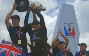 Burling and Ashby raise cup during parade