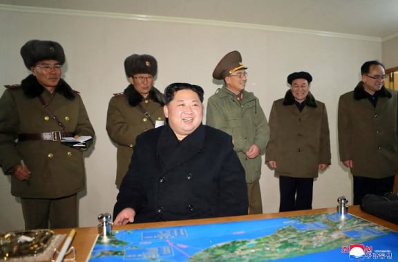 A photo released by North Korea's official Korean Central News Agency shows North Korean leader Kim Jong-Un  at the launching of the Hwasong-15 missile.