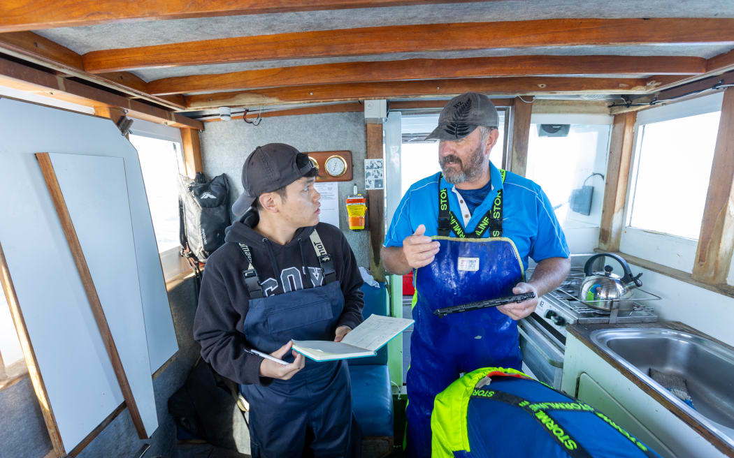 Massey University masters student Jerome Chua and Ocean Pearl Fisheries skipper and managing director Rob Ansley.