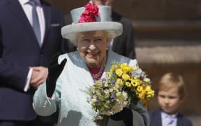 Queen Elizabeth II smiles and waves to members of the public as she leaves after attending the Easter Mattins Service at St. George's Chapel, Windsor Castle on April 21, 2019.