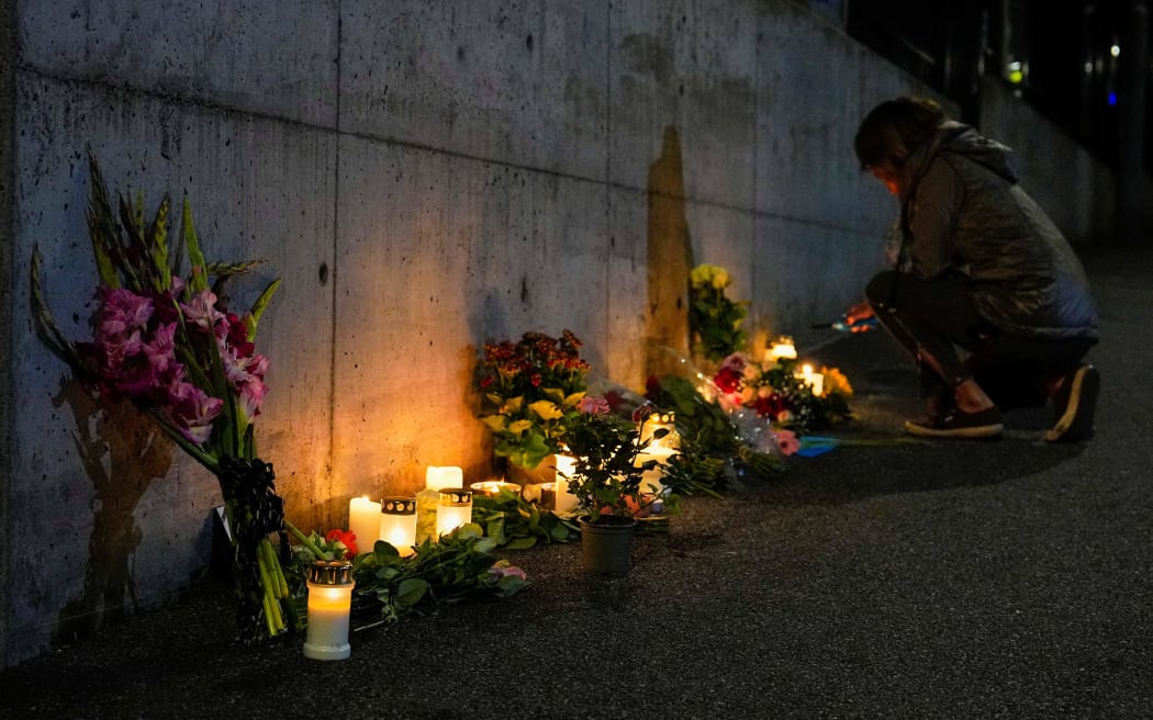 People light candles and lay flowers outside the British embassy in Oslo after the announcement of the death of Queen Elizabeth II, on September 9, 2022.