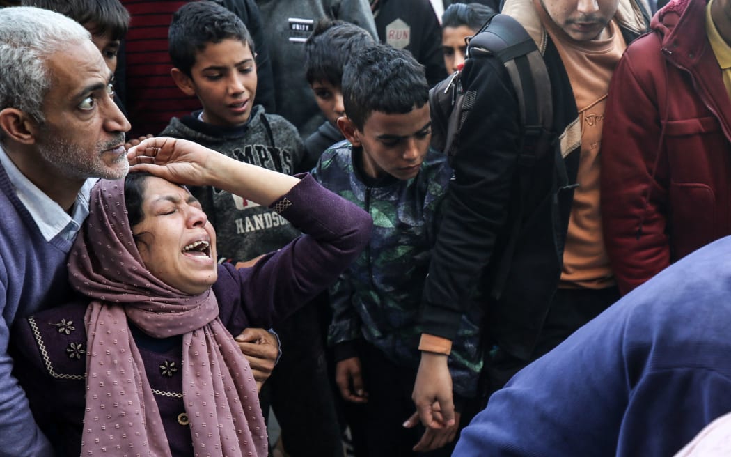 Relatives are mourning as they pray over the bodies of victims killed by Israeli bombing in Deir el-Balah, in the central Gaza Strip, on December 4, 2023. Israel is expanding its offensive against Hamas militants in the besieged Gaza, while international concern is deepening over the increasing civilian death toll in a war that was sparked by the attacks on October 7. (Photo by Majdi Fathi/NurPhoto) (Photo by MAJDI FATHI / NurPhoto / NurPhoto via AFP)
