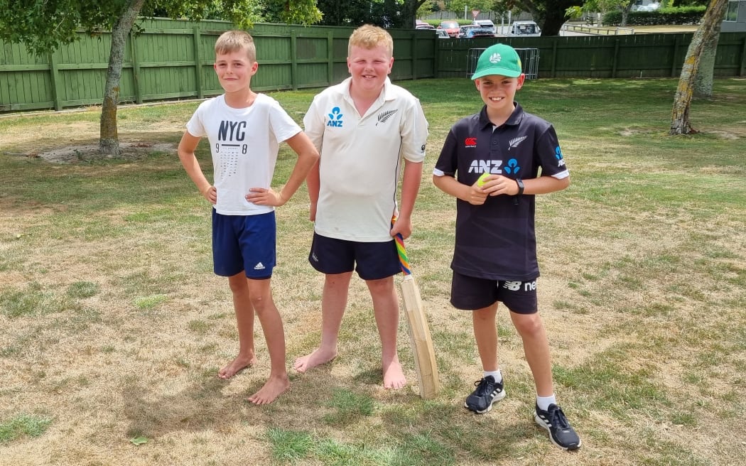 Jack Peters, 11, left, Max Gunning, 10, and Aiden McGregor, 11, were happy the lack of a crowd made room for their own cricket.
