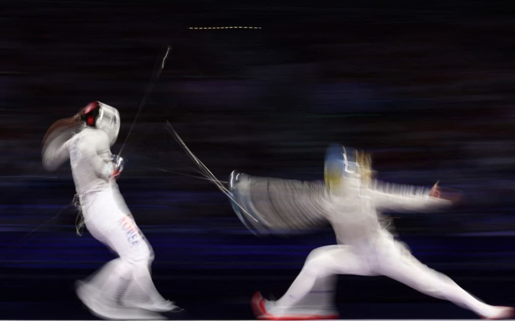 South Korea's Jeon Eun-hye (L) competes against Ukraine's Olga Kharlan in the women's sabre team gold medal bout between South Korea and Ukraine during the Paris 2024 Olympic Games at the Grand Palais in Paris, on August 3, 2024. (Photo by Franck FIFE / AFP)