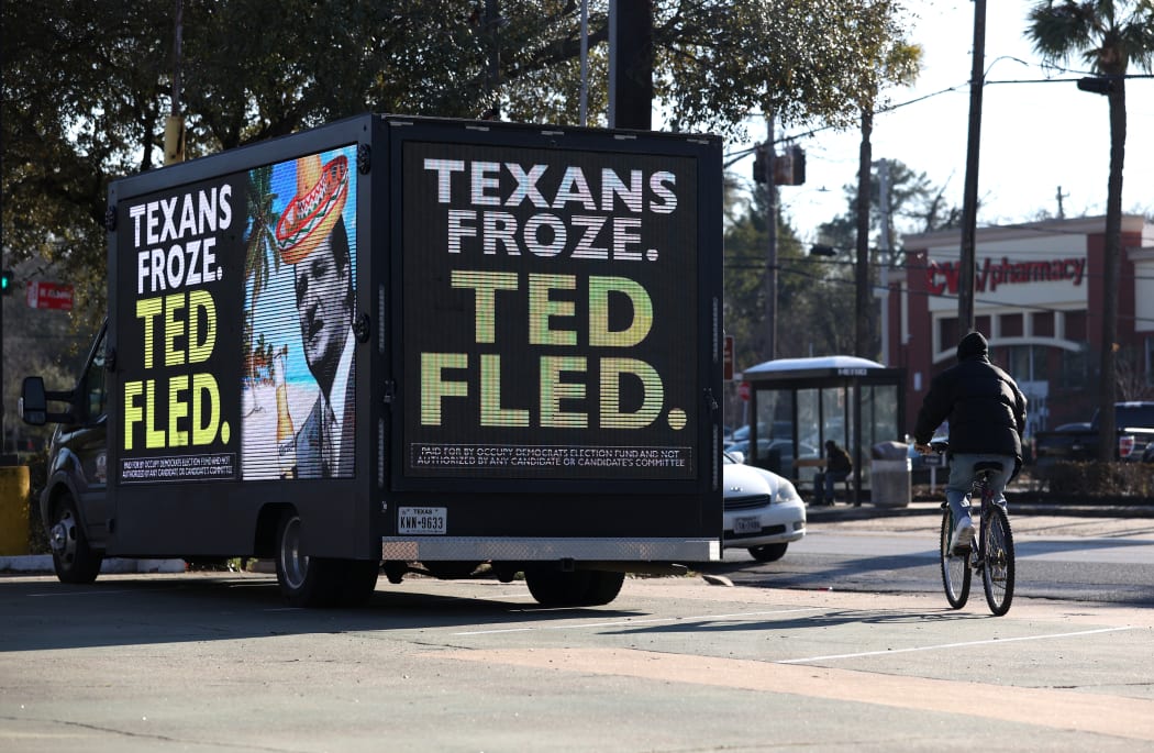 A digital billboard truck with an image of US Senator Ted Cruz sits in a parking lot near Cruz's home.