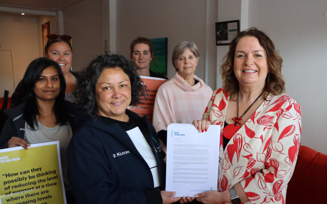 Nik Smith (front left) and her colleagues presented Education Minister Jan Tinetti (front right) with a 5700 signature petition.