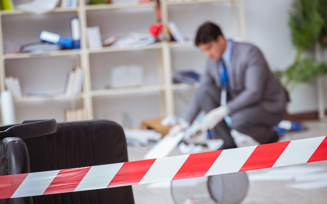 Young man during crime investigation in office