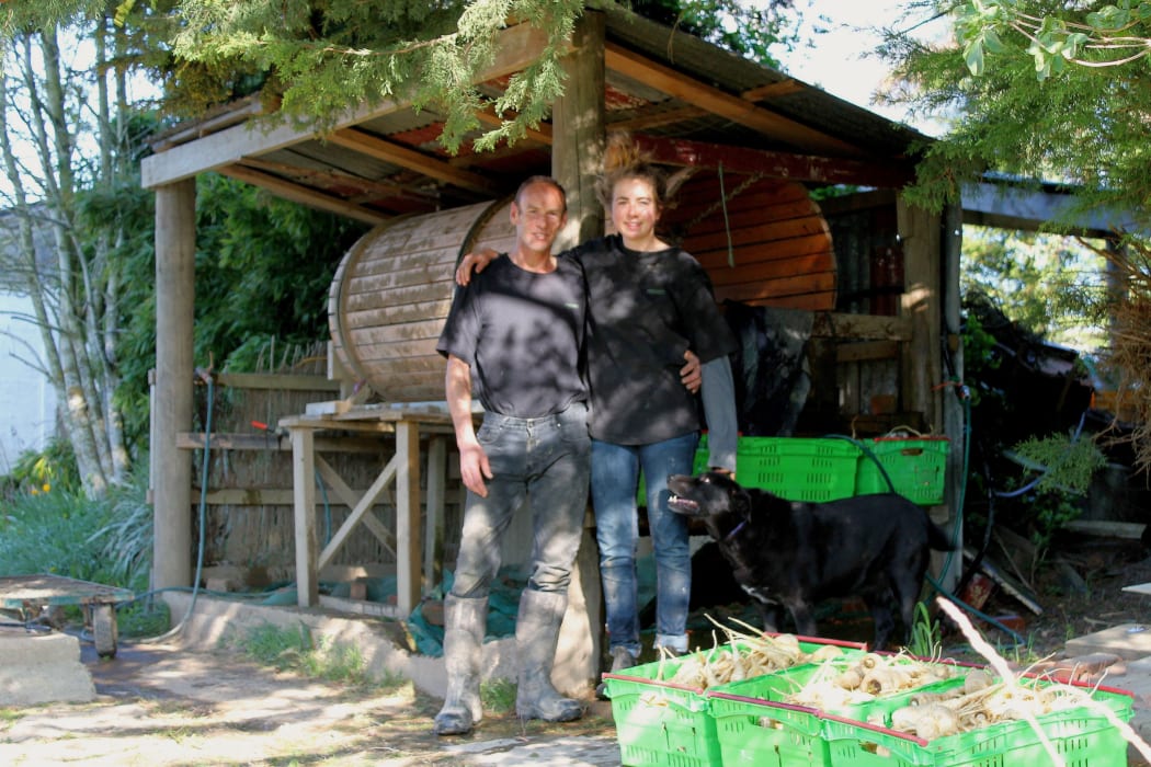 Shaun McVicker and Janine Gerland  in front of a commercial vegetable cleaner at Wairuna Organics.