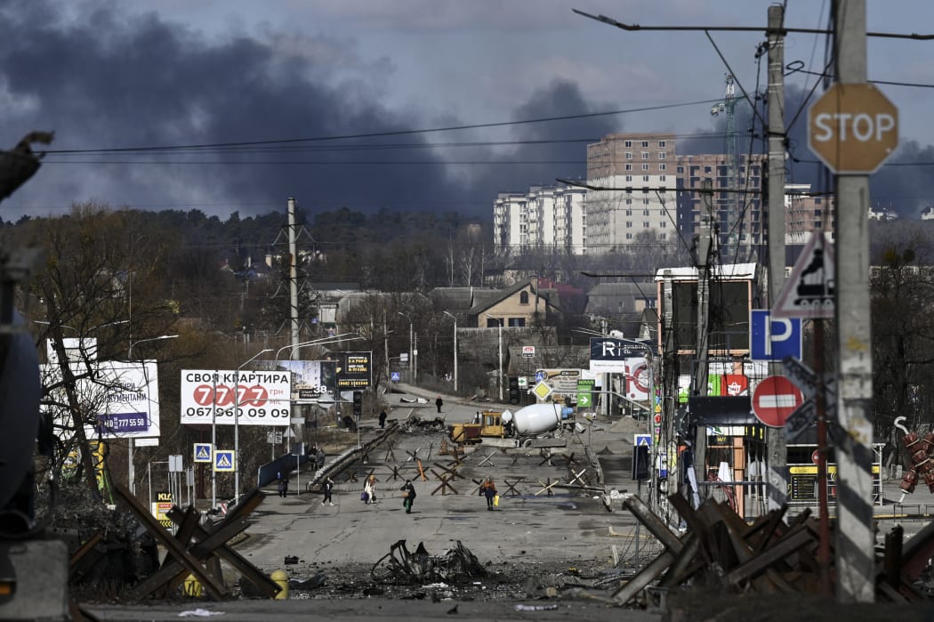 Residents evacuate the city of Irpin, north of Kyiv, on 10 March, 2022.