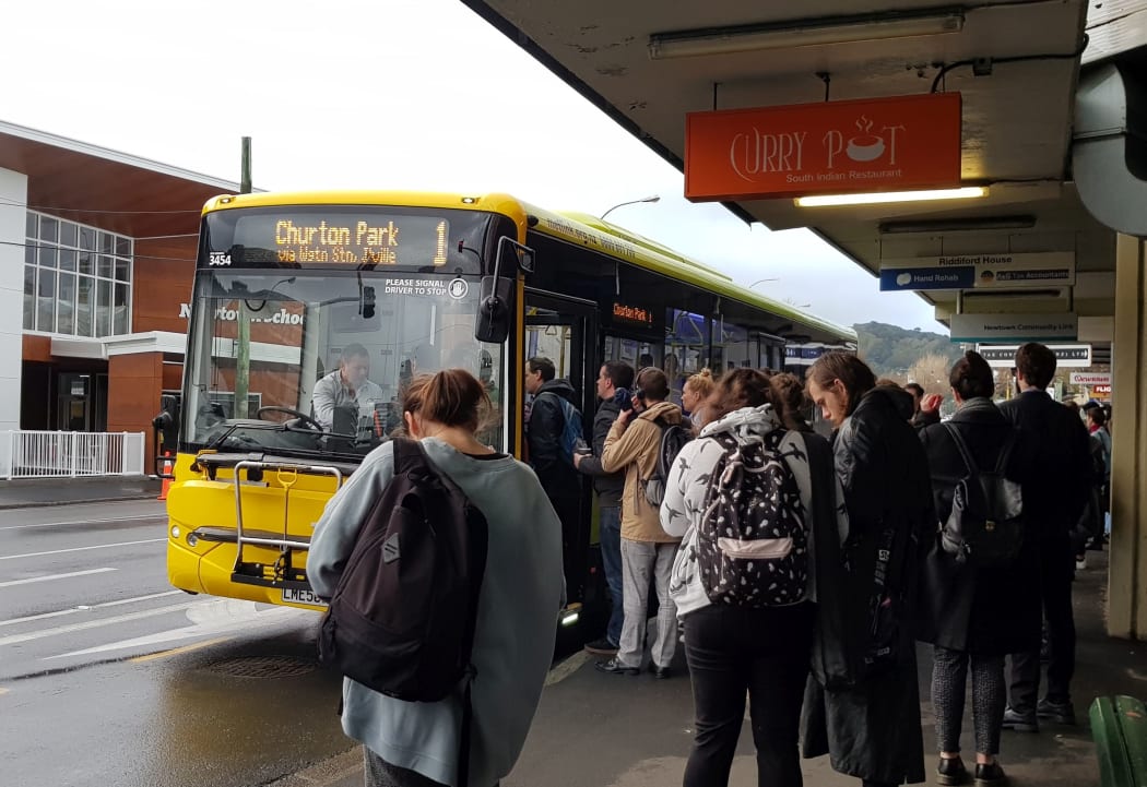 Commuters at a bus stop in Newtown