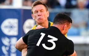 Ryan Crotty of New Zealand tackles Australia's Dane Haylett-Petty in the Bledisloe Cup test in Yokohama last year.