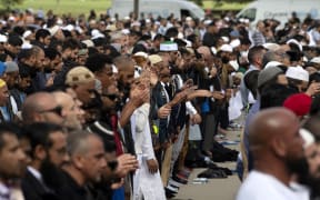 Muslims participate in Friday prayers led by Gamal Fouda, imam of Al Noor mosque, during a gathering for prayers and to observe two minutes of silence for victims of the twin mosque massacre at Hagley Park, Christchurch,March 22, 2019.(Photo by Marty MELVILLE / AFP)