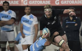 All Blacks Number 8 Kieran Read runs through a tackle by Argentina's Los Pumas' wing Juan Imhoff during the 2014 Rugby Championship.