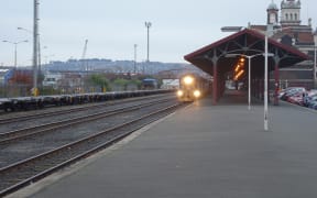 A locomotive and carriages used on Dunedin's Taieri Gorge Railway leaving the city