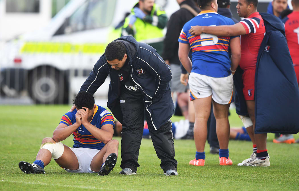 Dejected St Thomas' player Patrick Elia is consoled after losing by golden point.
Kelston Boys High School v St Thomas of Canterbury.â¨NZRL National Secondary Schools Rugby League Championships, Bruce Pulman Park, Auckland. 7 September 2017. Â© Copyright Photo : Andrew Cornaga / www.photosport.nz