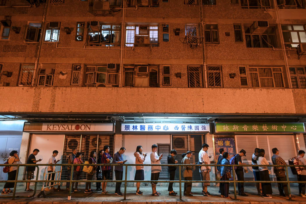 People queue to cast their vote during the district council elections in Tseung Kwan O district in Hong Kong on November 24, 2019.