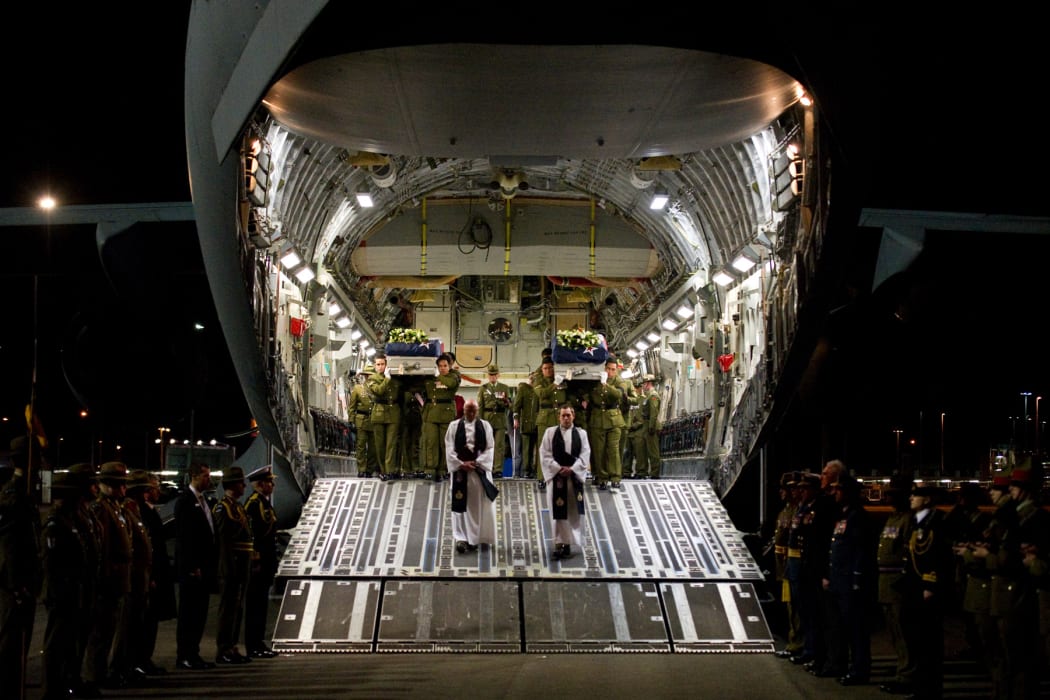 Military officials pay tribute to Lance Corporal Rory Malone and Lance Corporal Pralli Durrer as they are carried off a US Air Force C-17 aircraft.