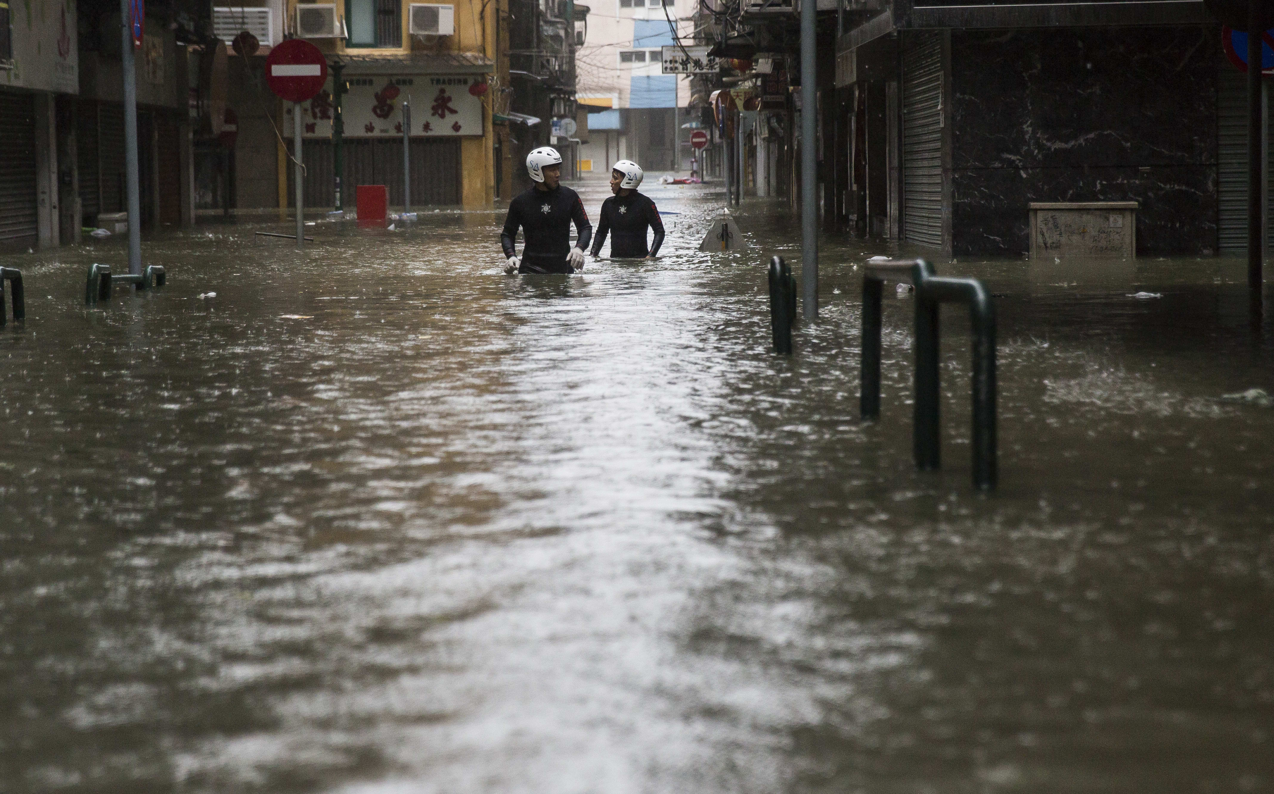 Rescue workers make their way through floodwaters during a rescue operation during Super Typhoon Mangkhut in Macau.