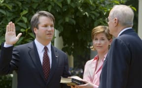 Brett Kavanaugh (left) pictured in 2006 being sworn in as a US Court of Appeals Judge for the District of Columbia.