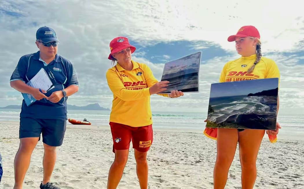 Kath Manning (middle), the club captain at Waipu Cove Surf Life Saving Club, teaches members of the Chinese community how to identify hazards in the water.
