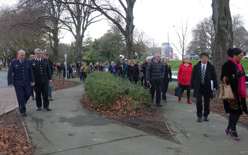 People walking to the proposed site of the national memorial for victims of the February 2011 earthquake on the edge of the Avon River.