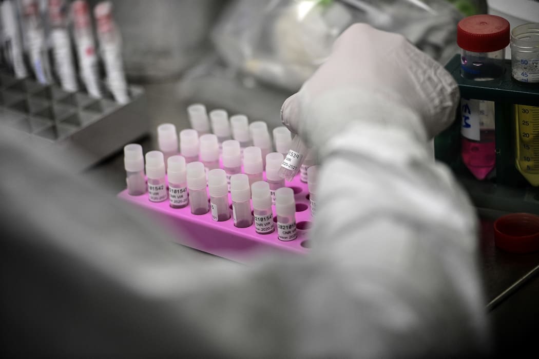 A laboratory technician wearing protective equipment works on the genome sequencing of the SARS-CoV-2 virus (Covid-19) and its variants at the Centre National de Reference of respiratory infections viruses of the Pasteur Institute in Paris on January 21, 2021.
