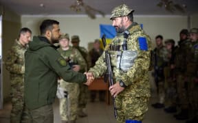 Ukrainian President Volodymyr Zelensky (L) awarding Ukrainian servicemen during his visit to de-occupied city of Izium, Kharkiv region. Zelensky visited the east Ukraine city - one of the largest recently recaptured from Russia by Kyiv's army in a lightning counter-offensive - on 14 September, 2022, the military said.