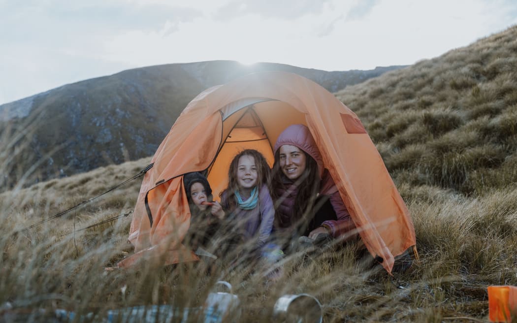 Sonia Barrish with her two children in a tent