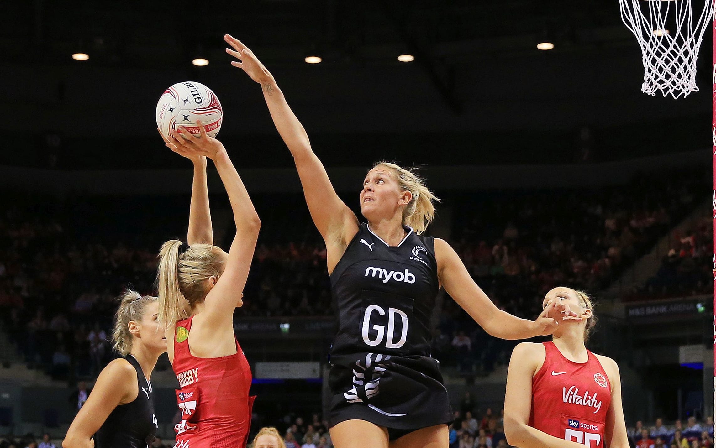 Helen Housby of England Roses lines up a shot challenged by Casey Kopua of New Zealand Silver Ferns