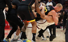 Mason Plumlee of the Phoenix Suns and Steven Adams of the Houston Rockets are seen engaging in a scuffle during an NBA game, 2025.