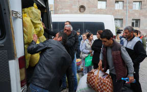 Refugees load their cars as they leave the Red Cross registration center, in Goris, on September 25, 2023. The first group of Nagorno-Karabakh refugees since Azerbaijan's lighting assault against the separatist region entered Armenia on September 24, 2023, an AFP team at the border said. The group of a few dozen people passed by Azerbaijani border guards before entering the Armenian village of Kornidzor, where they were registered by officials from Armenia's foreign ministry. (Photo by ALAIN JOCARD / AFP)