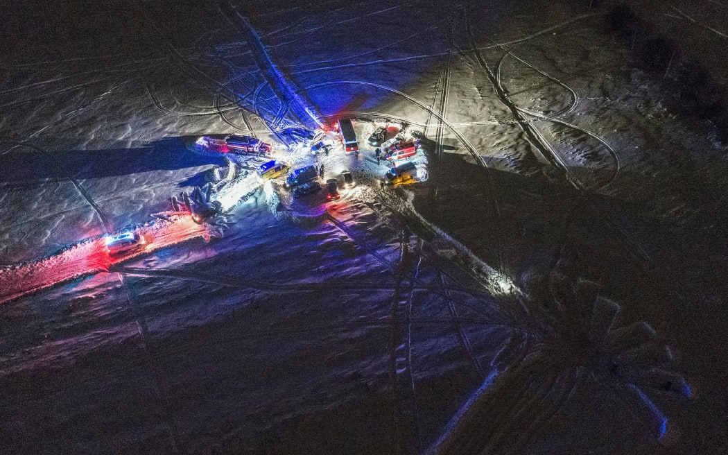 An aerial view of emergency vehicles arriving near the site of the air crash in Ramensky district near Moscow.